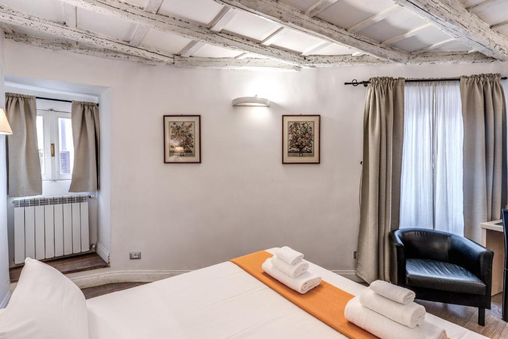 a bedroom with a bed and a black chair at Magenta Deluxe Cancello in Rome