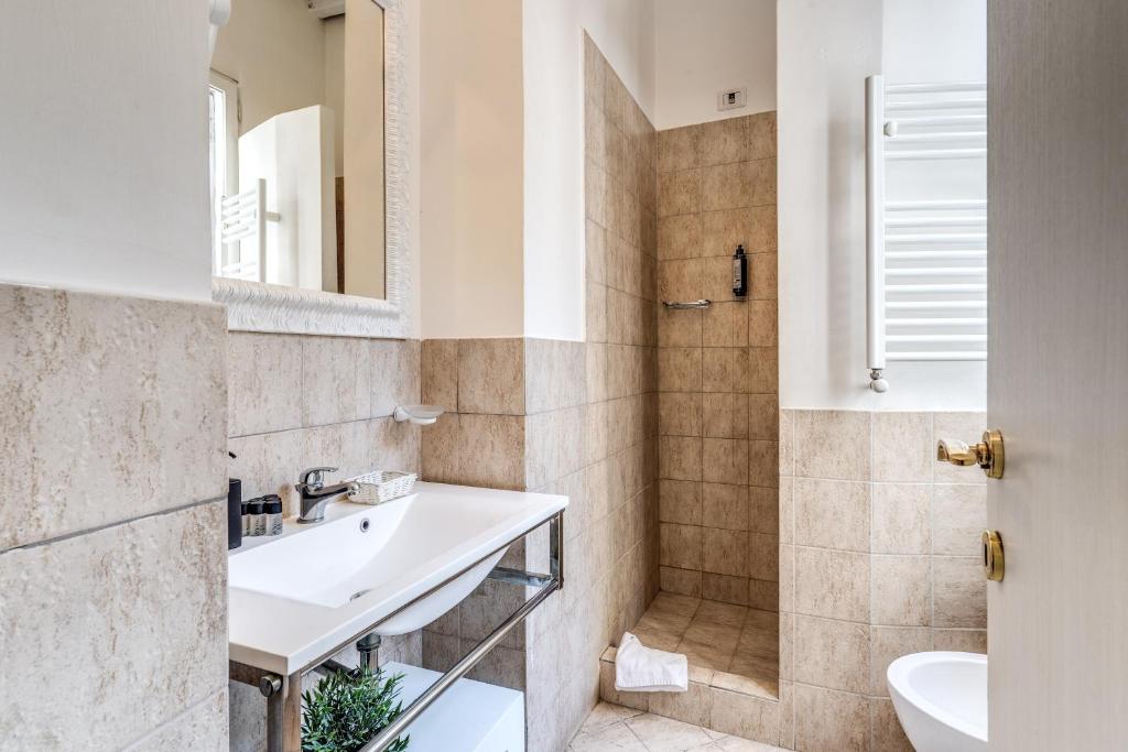 a bathroom with a sink and a shower at Magenta Deluxe Cancello in Rome