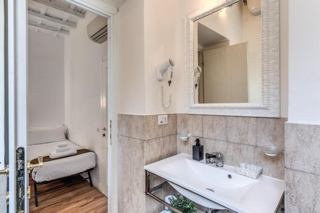 a bathroom with a sink and a mirror at Magenta Deluxe Cancello in Rome