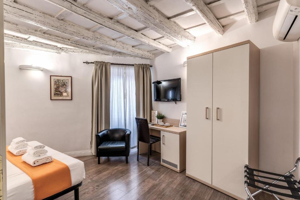 a hotel room with a bed and a desk at Magenta Deluxe Cancello in Rome