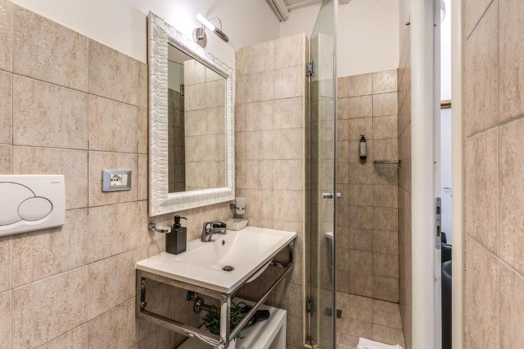 a bathroom with a sink and a shower at Magenta Deluxe Cancello in Rome