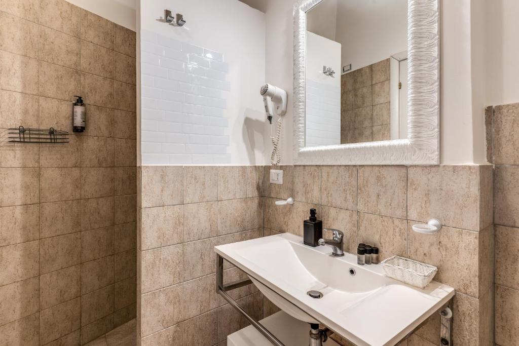 a bathroom with a sink and a mirror at Magenta Deluxe Cancello in Rome