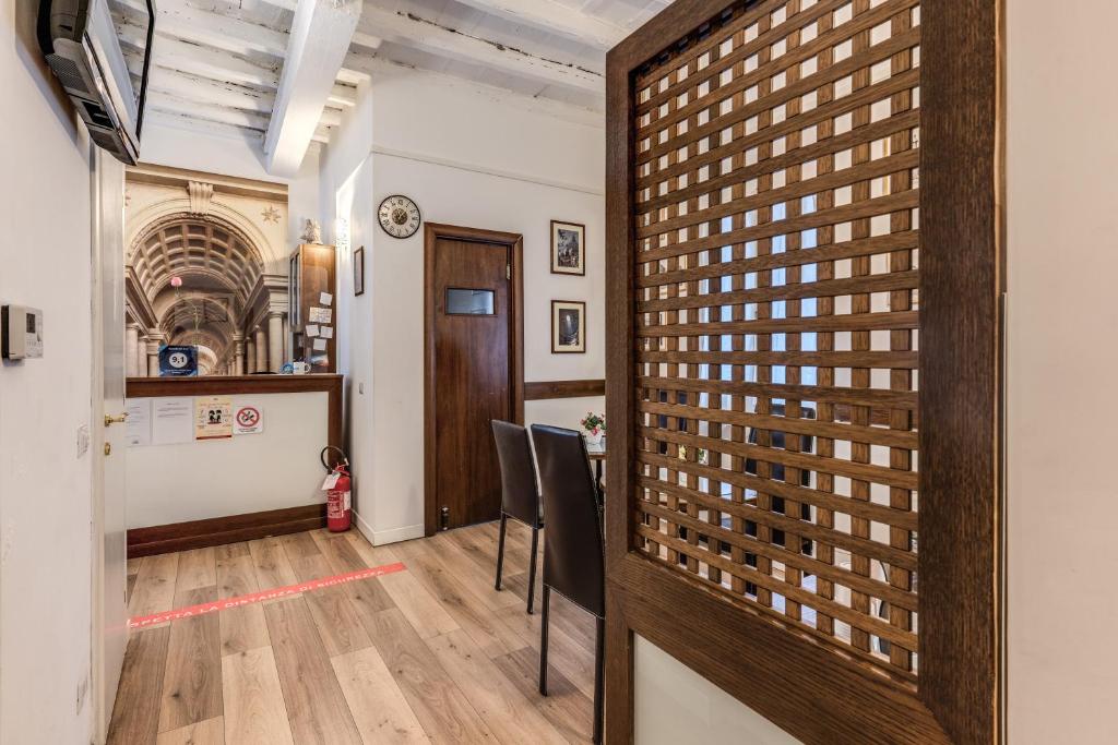 a room with chairs and a table and a wall at Magenta Deluxe Cancello in Rome
