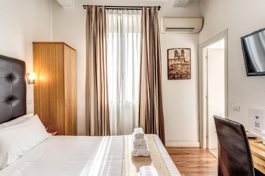 a hotel room with a bed and a window at Magenta Deluxe Cancello in Rome