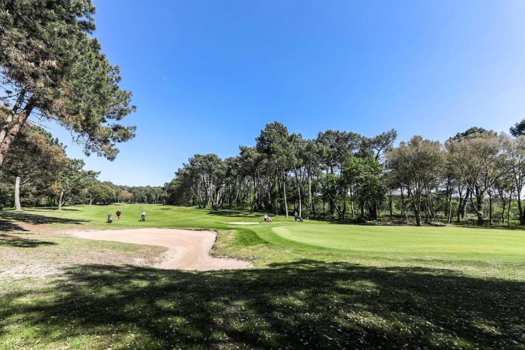 a golf course with people playing on a green at Le Domaine du Golf de Pinsolle - maeva Home - Appartement 2 pièces 6 person 574 in Soustons