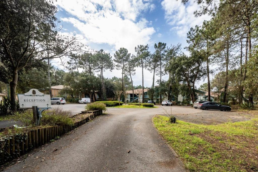 a driveway in a residential neighborhood with cars parked at Le Domaine du Golf de Pinsolle - maeva Home - Appartement 2 pièces 6 person 574 in Soustons