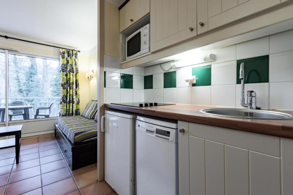 a kitchen with a sink and a dishwasher at Le Domaine du Golf de Pinsolle - maeva Home - Appartement 2 pièces 6 person 574 in Soustons
