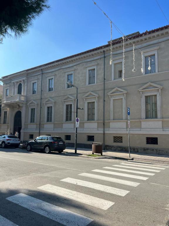 ein großes weißes Gebäude mit davor geparkt in der Unterkunft Palazzo Lucangeli in Porto Recanati