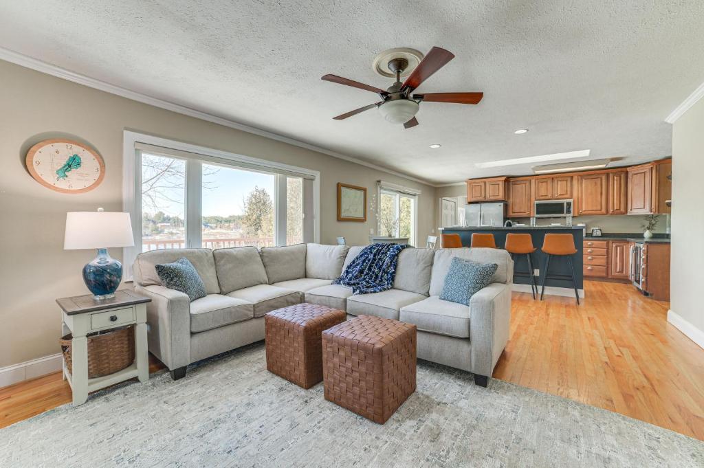 a living room with a couch and a ceiling fan at Riverfront Cheboygan Home with Deck and Boat Dock! in Cheboygan