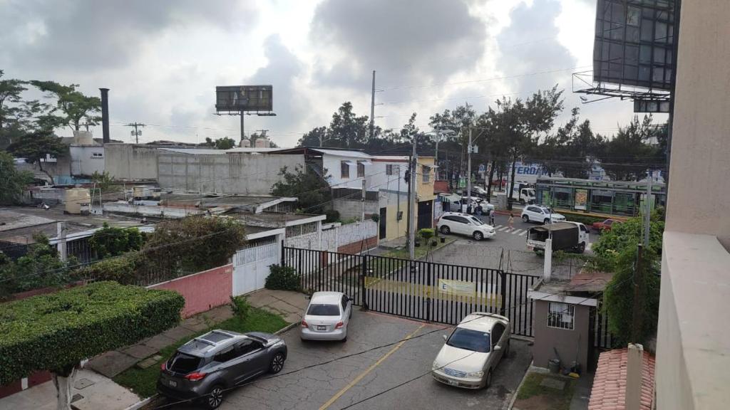 a group of cars parked in a parking lot at Private room within apartment in zone 7 in Guatemala