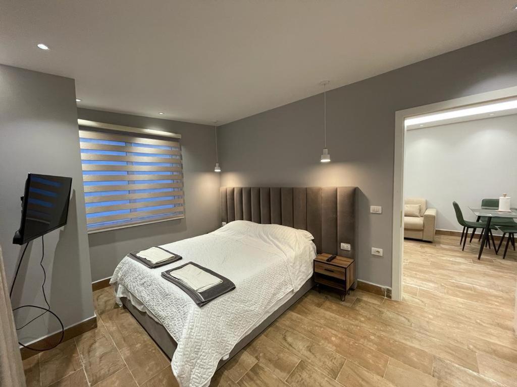 a bedroom with a bed and a tv in it at Sevians Apartments in Golem