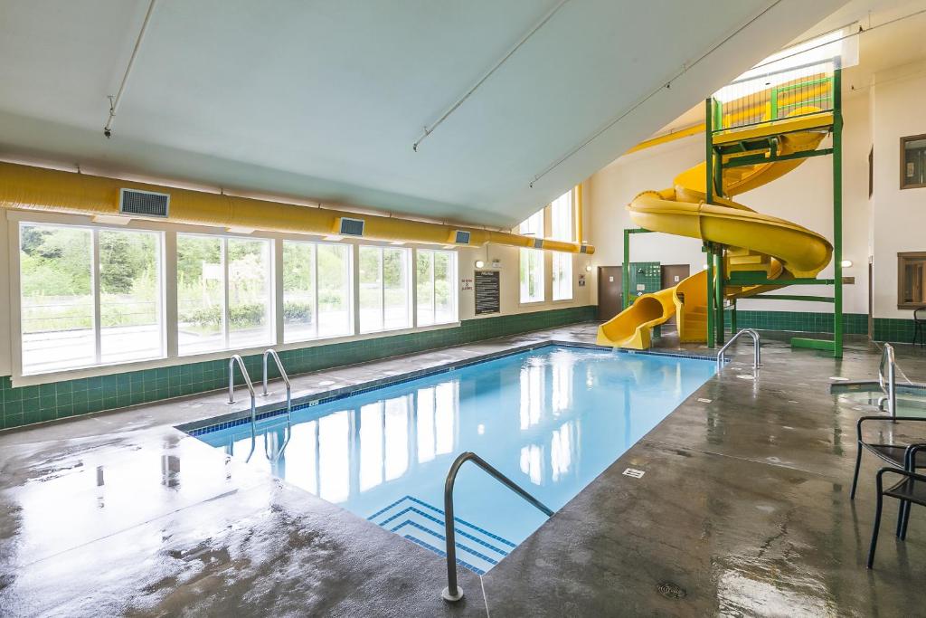 a swimming pool with a slide in a building at Mountain Retreat in Squamish