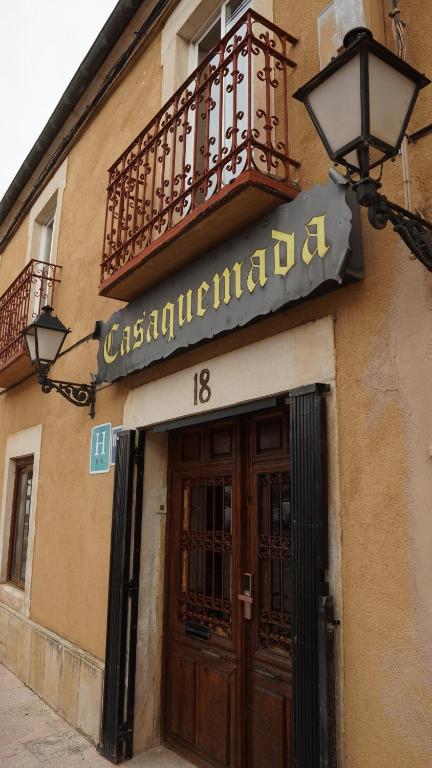 a sign on the side of a building with a door at HOTEL RIAZA in Riaza