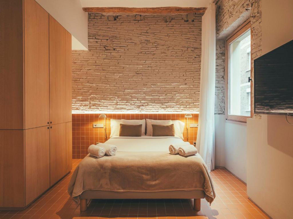 Postel nebo postele na pokoji v ubytování Boutique Apartments 23 Barcelona