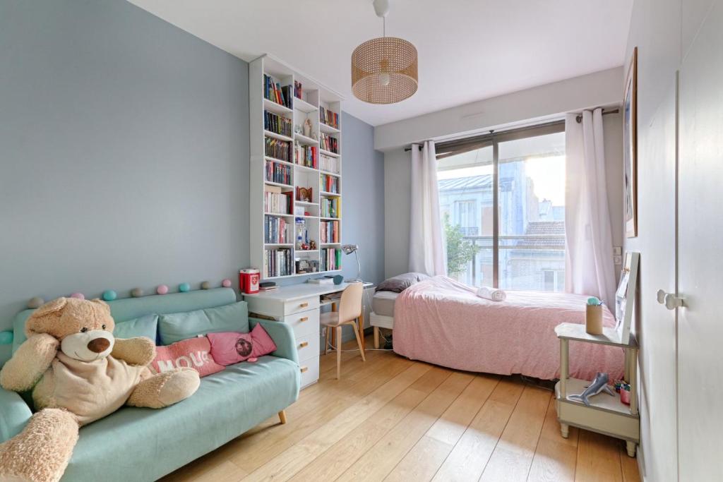a childs room with a blue couch and a bedroom at Résidor - Spacious and bright apartment ! in Levallois-Perret