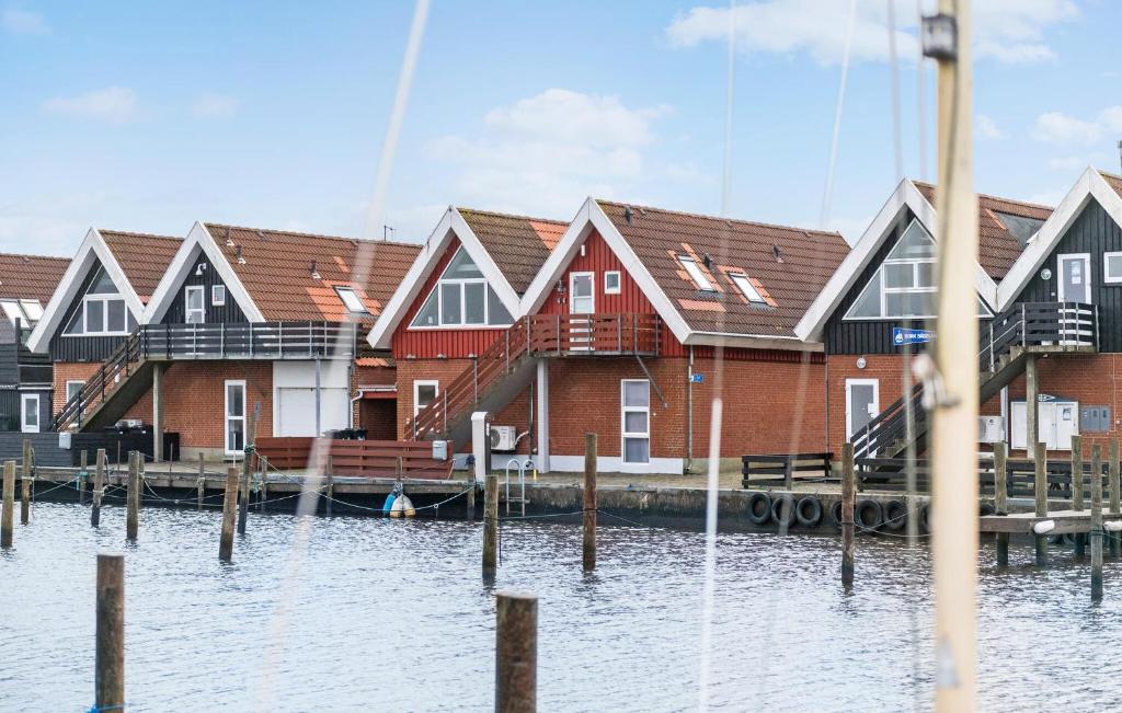 a row of houses on a dock in the water at 2 Bedroom Gorgeous Apartment In Hemmet in Hemmet