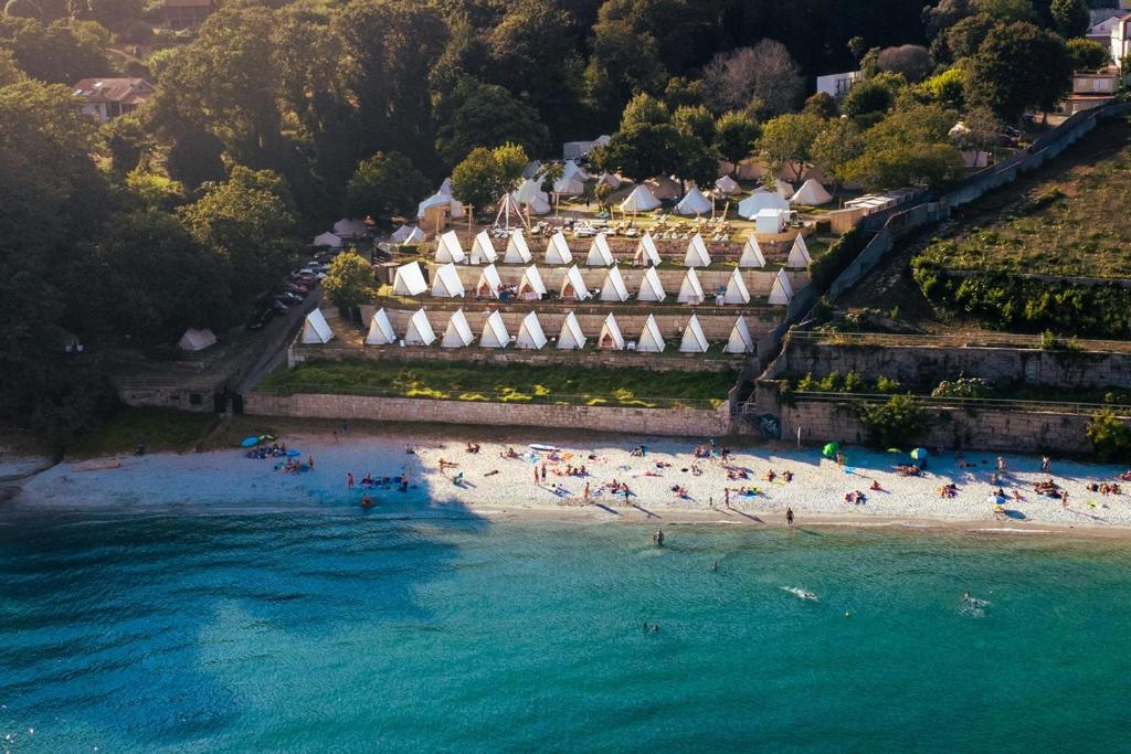 an aerial view of a beach with people on it at Kampaoh Ría de Vigo in Moaña