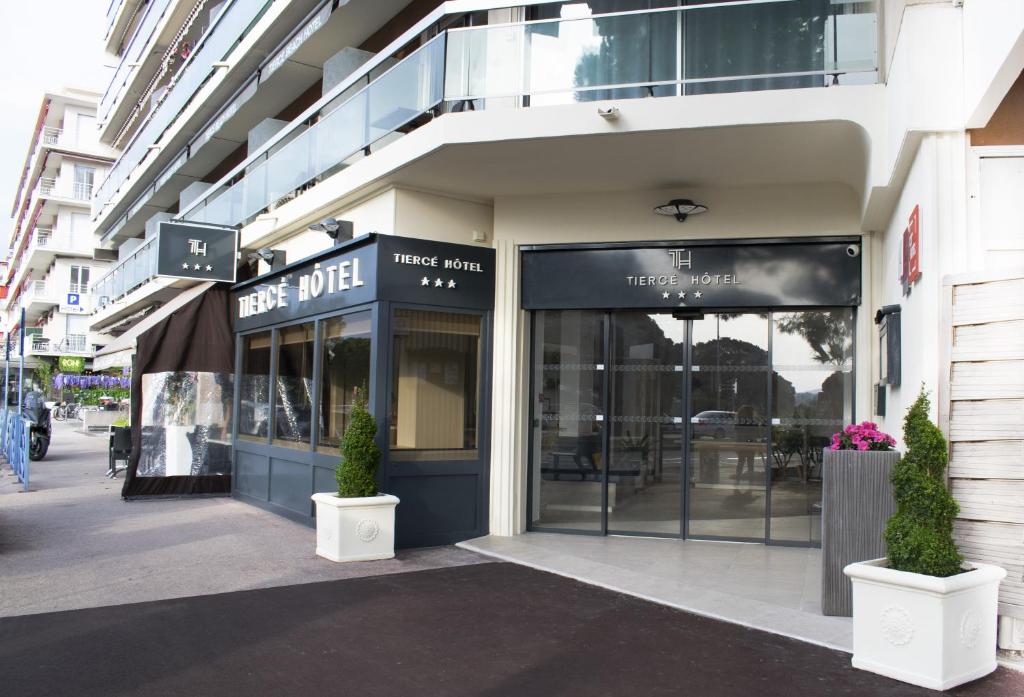 a store front of a building on a street at Tiercé Hotel in Cagnes-sur-Mer