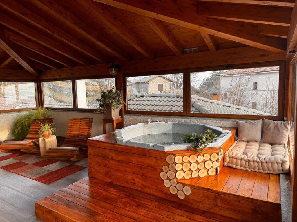 a large room with a hot tub on a porch at Albergo Canella in Fuipiano Valle Imagna