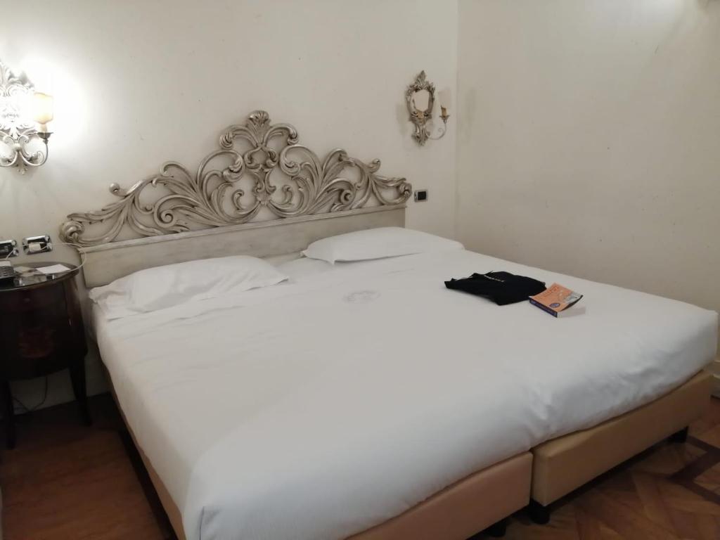 Uma cama ou camas num quarto em Hotel Aventino