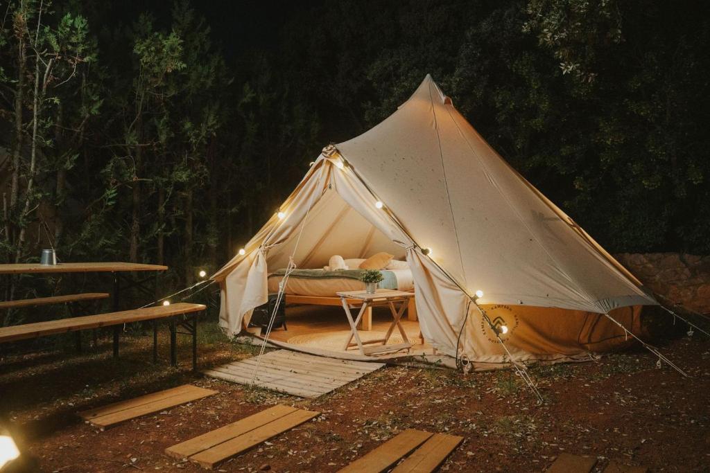 a tent with a bed in it with lights at Kampaoh Alquézar in Alquézar