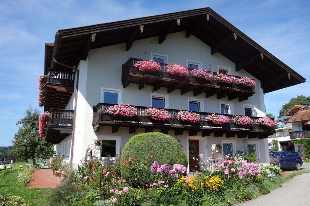 a building with flower boxes on the side of it at Gästehaus Nigglhof in Rimsting