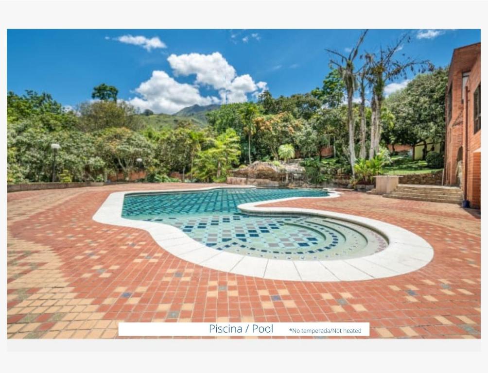 a swimming pool with a tile floor and a brick driveway at Finca el Castillo Copacabana. Top 1 en Fincas! in Copacabana