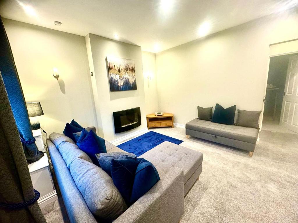 a living room with a couch and a fireplace at Stone Villas By Alternative Stays in Hednesford