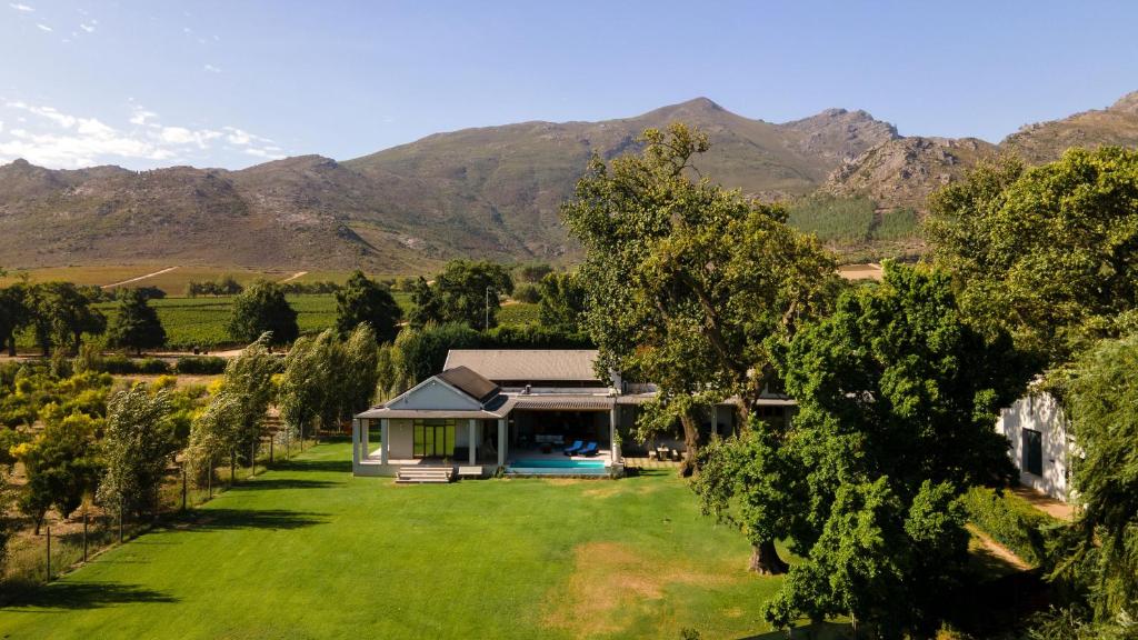 an aerial view of a house with mountains in the background at Franschhoek Homestead in Franschhoek