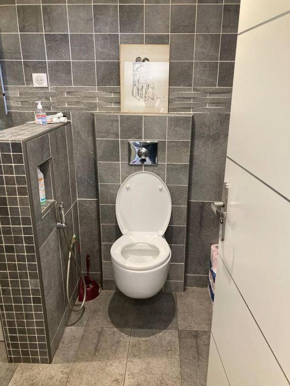 a bathroom with a toilet in a tiled room at Propriete de 2 chambres avec terrasse et wifi a Saint Denis in Saint-Denis