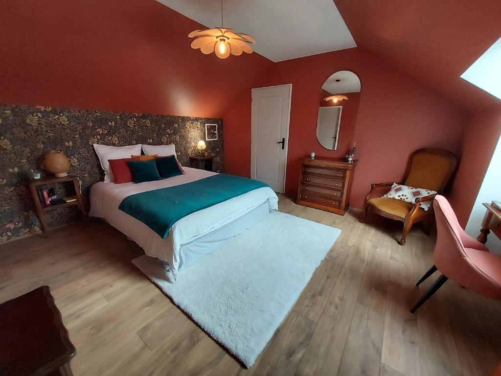 una camera con un grande letto e una sedia di Grande suite & salon privé, proche du circuit a Magny-Cours