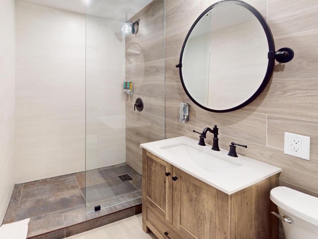 a bathroom with a sink and a mirror at The Grand Resort and Spa & Worthington All Male in Fort Lauderdale