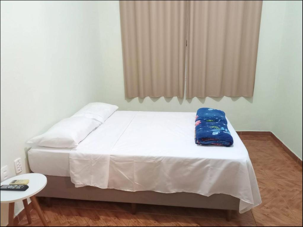 Giường trong phòng chung tại Suíte privativa Gigá