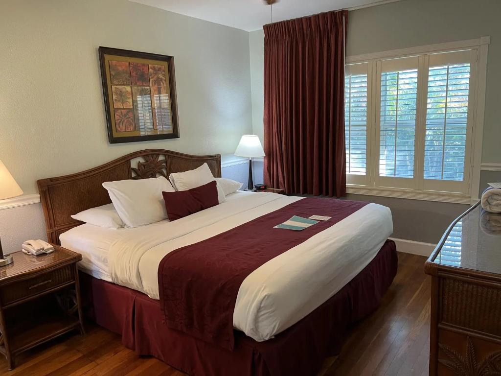 a bedroom with a large bed and a window at The Grand Resort and Spa & Worthington All Male in Fort Lauderdale
