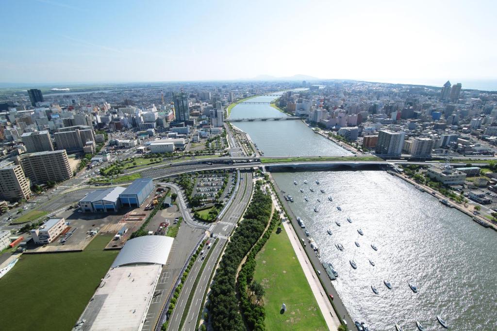 an aerial view of a river and a city at Hotel Nikko Niigata in Niigata