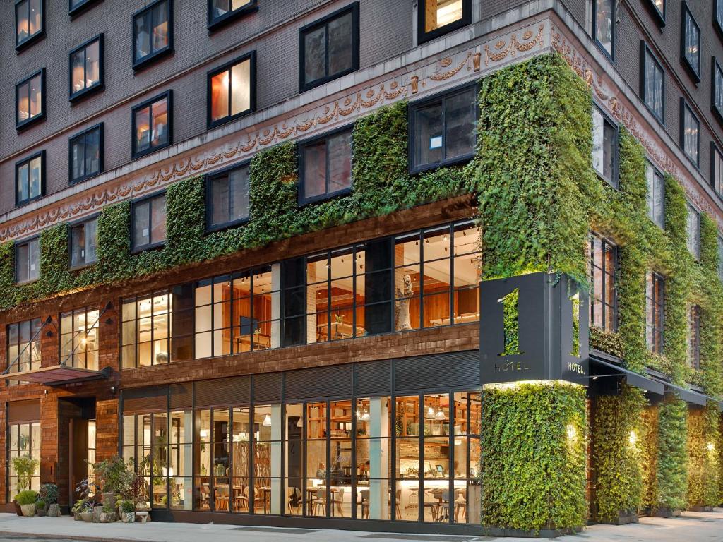 a building with a green ivy covered facade at 1 Hotel Central Park in New York
