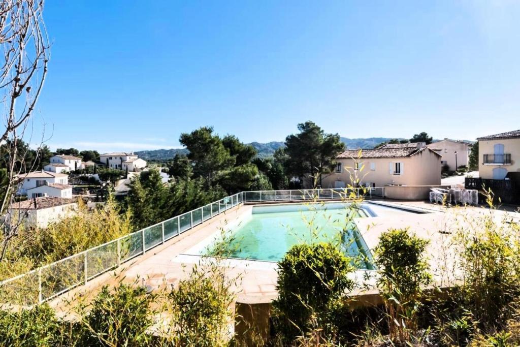 a view of a swimming pool in a villa at Les Coteaux de Pont Royal en Provence - maeva Home - Appartement 3 pièces 6 214 in Mallemort
