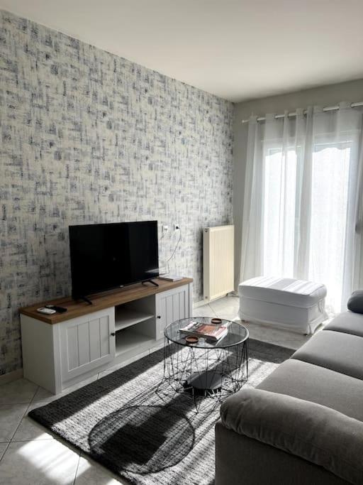 a living room with a tv and a couch at Letty's cozy flat apartment in Perea