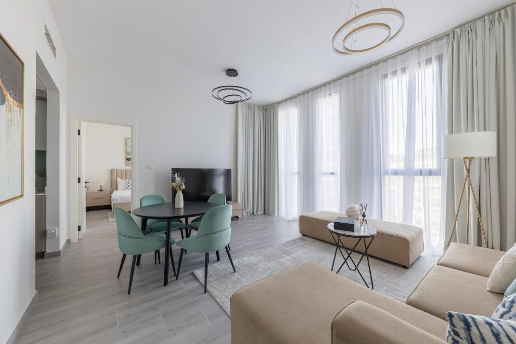 a living room with a couch and a table at Fresh & Quiet 1BR at Midtown Noor 4 Tower in Dubai