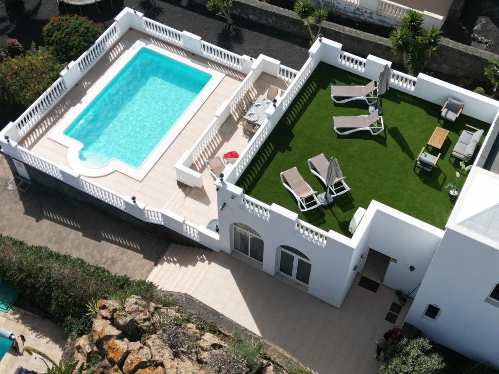 an aerial view of a house with a swimming pool at Casa Alba - By AZ Rentals in Tías