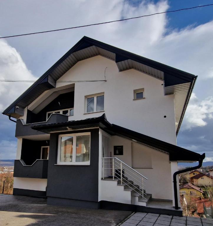 a white house with a black roof at BORIĆI in Bihać