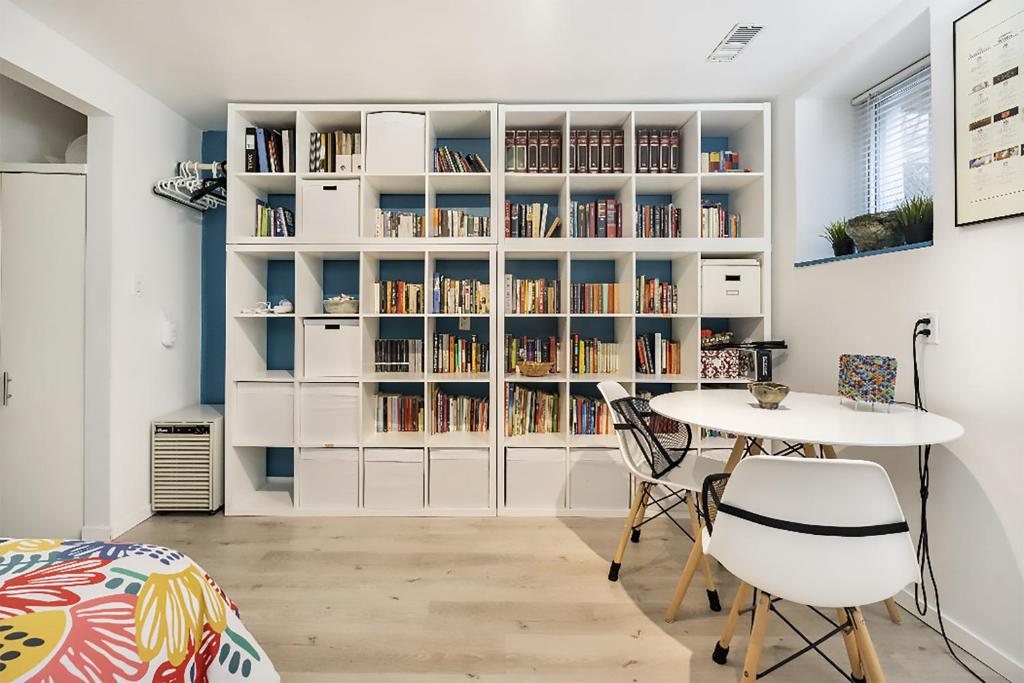 a room with a book shelf filled with books at An independent beach retreat steps from the lake and right in the city in Toronto