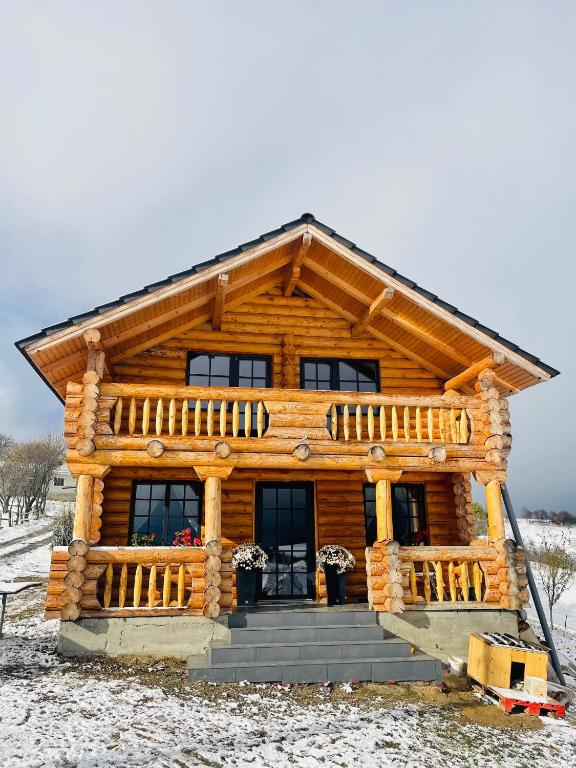 a log cabin in the snow at BearHouse Chalet in Poiana Mărului