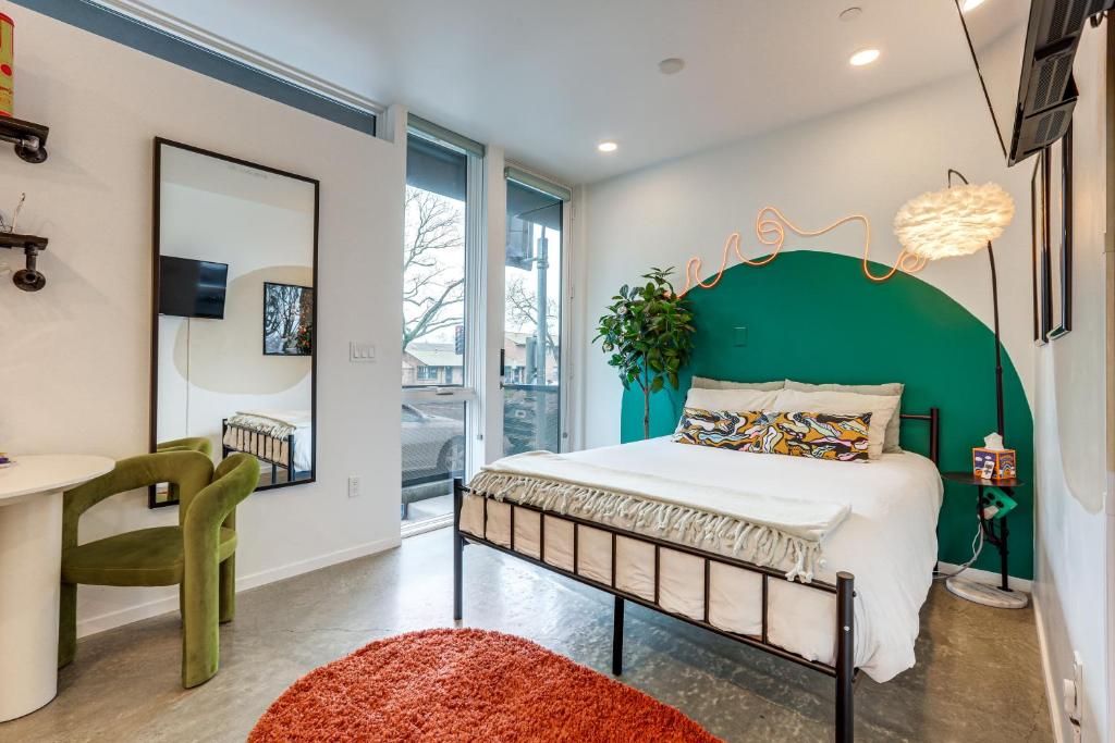 a bedroom with a large bed with a green headboard at Pet-Friendly Sacramento Studio Rental in Sacramento