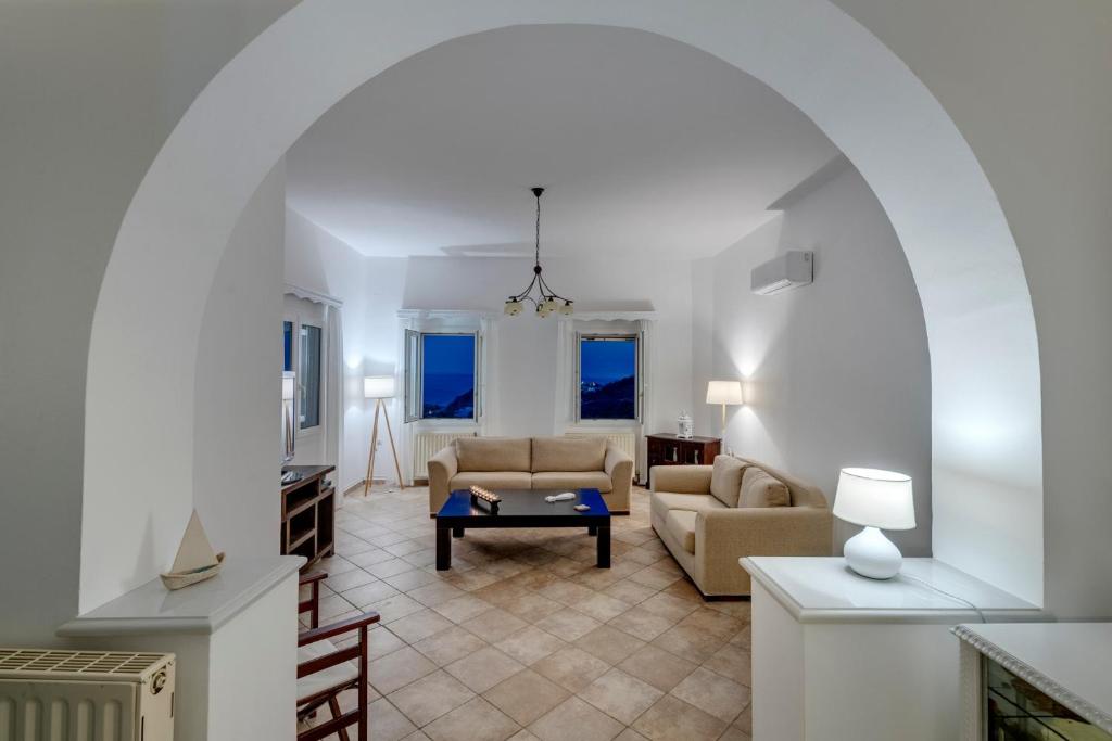 a living room with a couch and a table at Villa la vue in Ano Syros