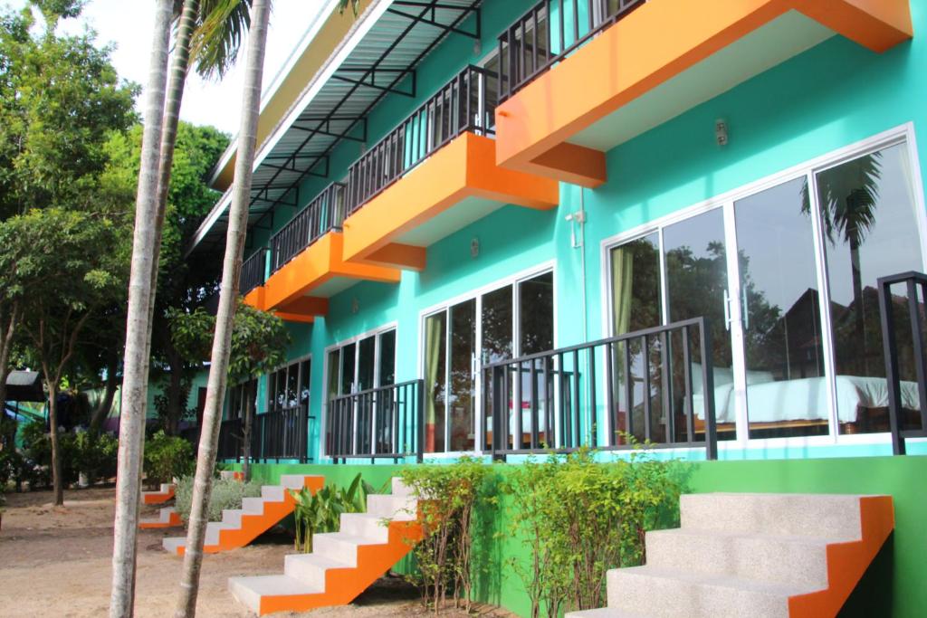a building with orange and green paint on it at Samui Poshtel in Chaweng