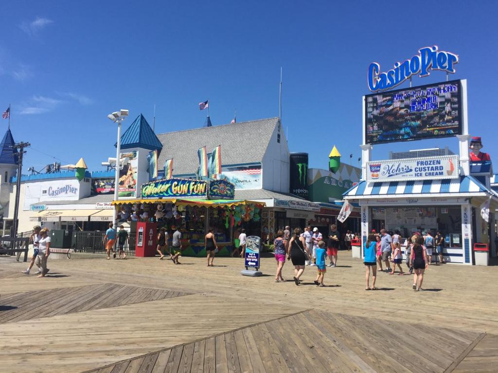 a group of people walking on a boardwalk at Two level, 2-Bedrm, 1 ½ Bathrm. in Seaside Heights