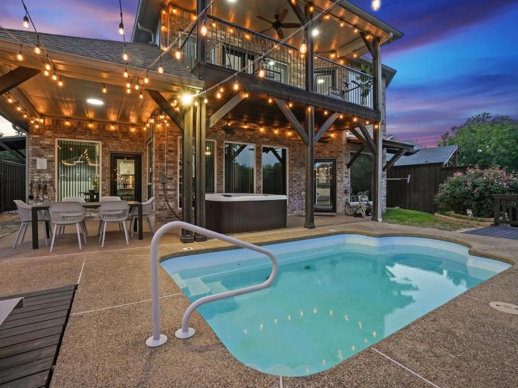 a patio with a swimming pool and a house at Clearview Castle - Pool* Jacuzzi Lake View in Lewisville