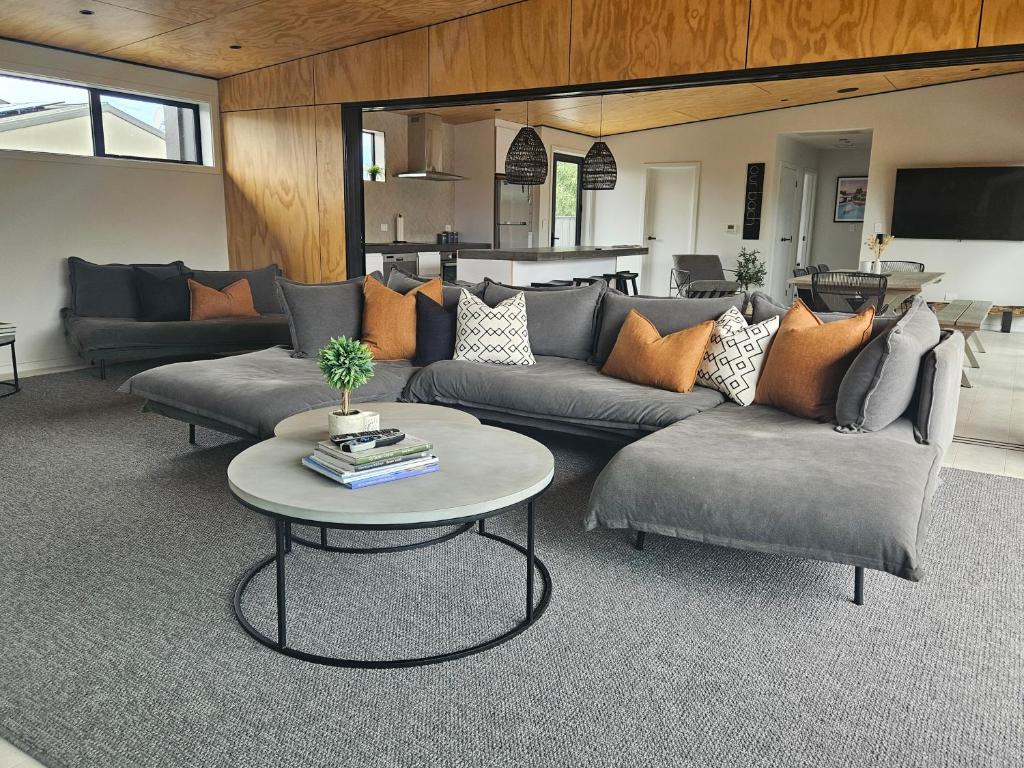 a living room with a couch and a table at The Totara Bach in Twizel