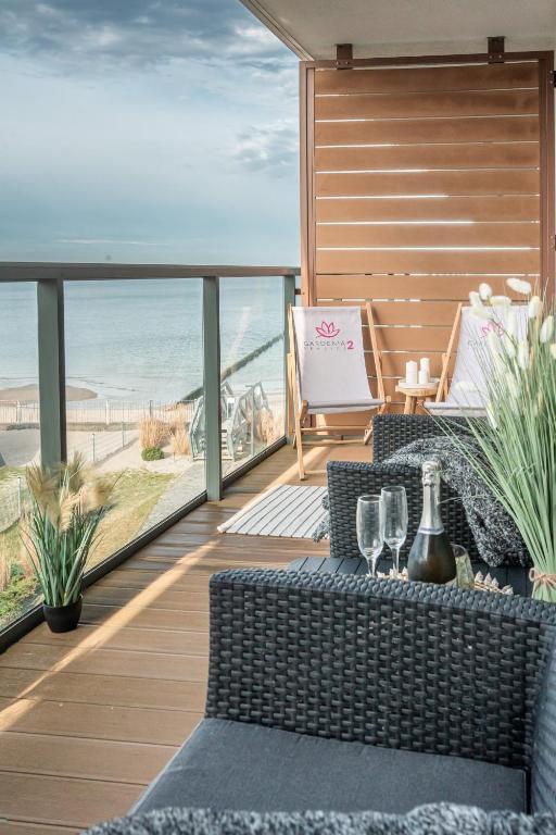 a balcony with a table and chairs and a view of the beach at Seaview Plaza in Dziwnów